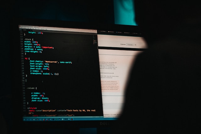 a man sits at a computer and writes code